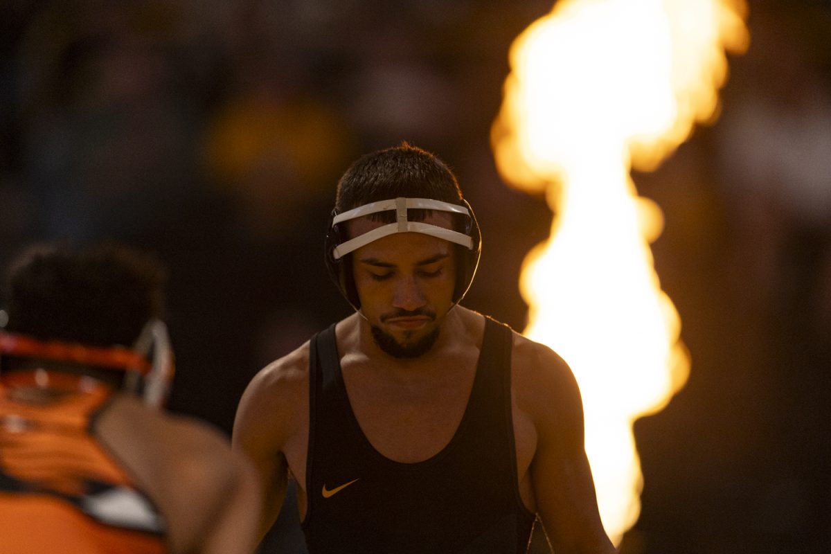 Iowa’s No. 1 141-pound Real Woods walks onto the mat before wrestling Oregon State’s No. 20 Cleveland Belton during a men’s wrestling dual between No. 3 Iowa and No. 16 Oregon State at Carver-Hawkeye Arena on Sunday, Nov. 19, 2023. Woods defeated Belton by technical fall, 18-3. The Hawkeyes defeated the Beavers, 25-11.
