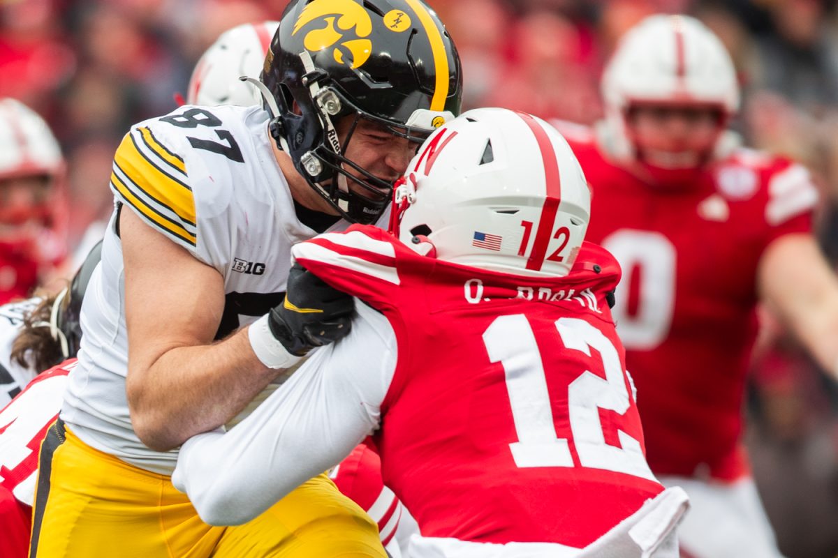 Iowa tight end Addison Ostrenga pushes Nebraska defensive back Omar Brown during a football game between No. 17 Iowa and Nebraska at Memorial Stadium in Lincoln Nebraska on Friday, Nov. 23, 2023. The Hawkeyes defeated the Cornhuskers 13-10.