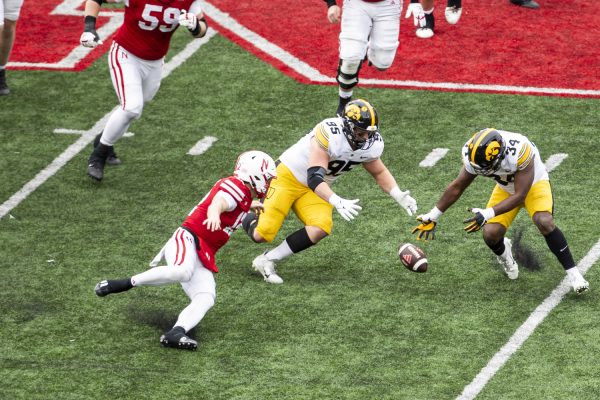 Iowa defensive lineman 	Aaron Graves and linebacker Jay Higgins dive for the ball during a football game between Iowa and Nebraska at Memorial Stadium in Lincoln Nebraska on Friday, Nov. 23, 2023. The Hawkeyes defeated the Cornhuskers 13-10.