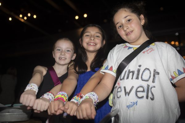 Milly, Lily, and Remi show their friendship bracelets during the parTay event at Big Grove Brewery on Monday, Nov. 13, 2023. The event was put on to support 29 local partner agencies of United Way of Johnson and Washington Counties. (Isabella Tisdale/ The Daily Iowan)