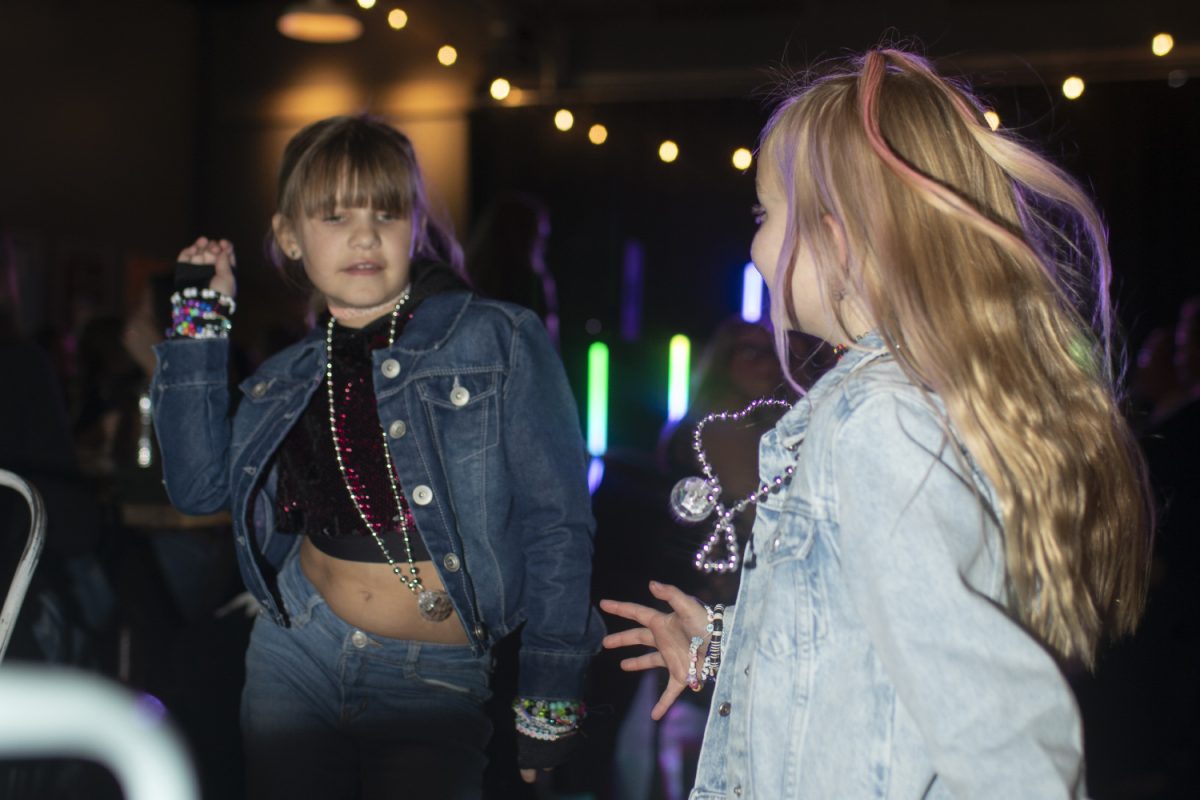 Charlotte, 7, and Ava, 8, dance to “Shake It Off” during the parTay event at Big Grove Brewery on Monday, Nov. 13, 2023. The event was put on to support 29 local partner agencies of United Way of Johnson and Washington Counties. 
