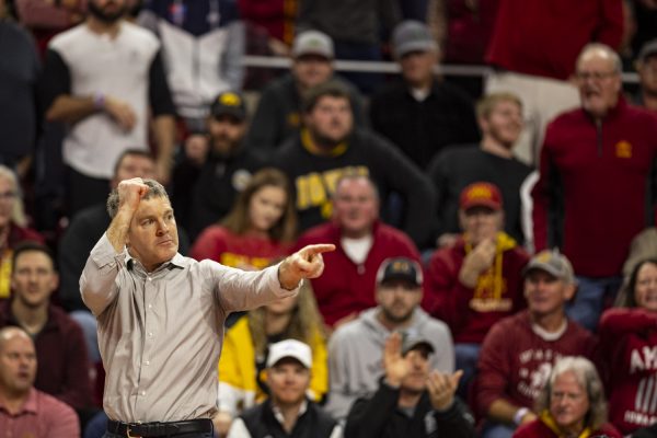 Iowa men’s wrestling head coach Tom Brands signals for stalling during a Cy-Hawk men’s wrestling dual between No. 4 Iowa and No. 8 Iowa State at Hilton Coliseum on Sunday, Nov. 26, 2023. The Hawkeyes defeated the Cyclones, 18-14.