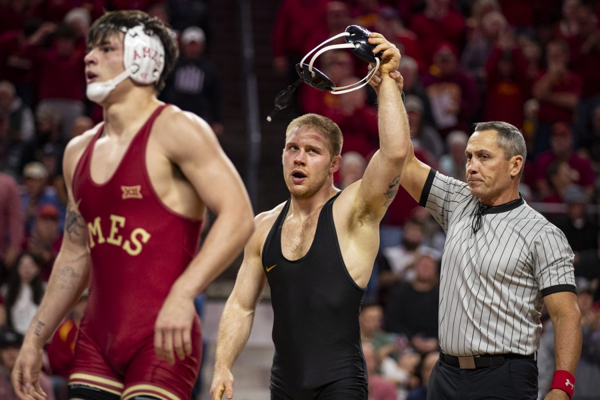 Iowa’s 174-pound Patrick Kennedy looks to the crowd while getting his hand raised after wrestling Iowa State’s No. 21 MJ Gaitan during a Cy-Hawk men’s wrestling dual between No. 4 Iowa and No. 8 Iowa State at Hilton Coliseum on Sunday, Nov. 26, 2023.