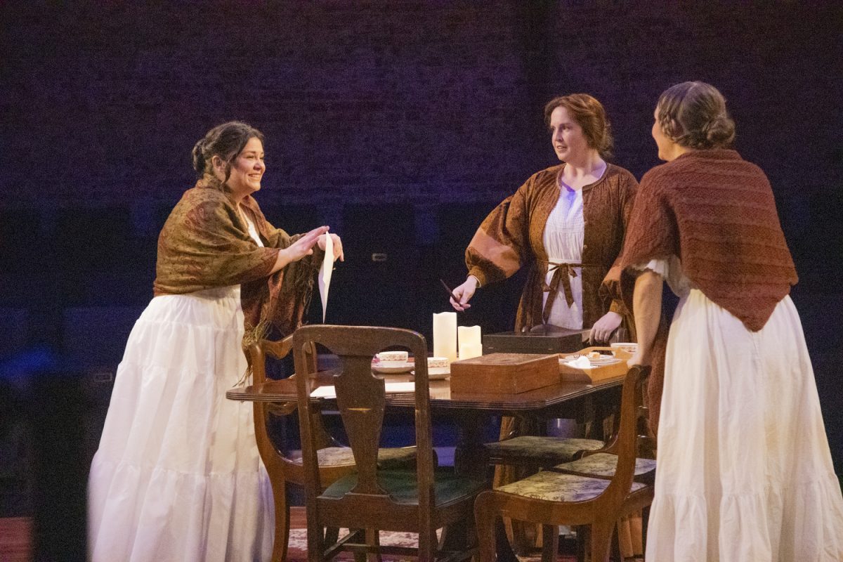 Charlotte Brontë, played by Katie Gucik, opens a letter during a production of “Brontë: The World Without” at Riverside Theater in Iowa City on Wednesday, Nov. 29, 2023.