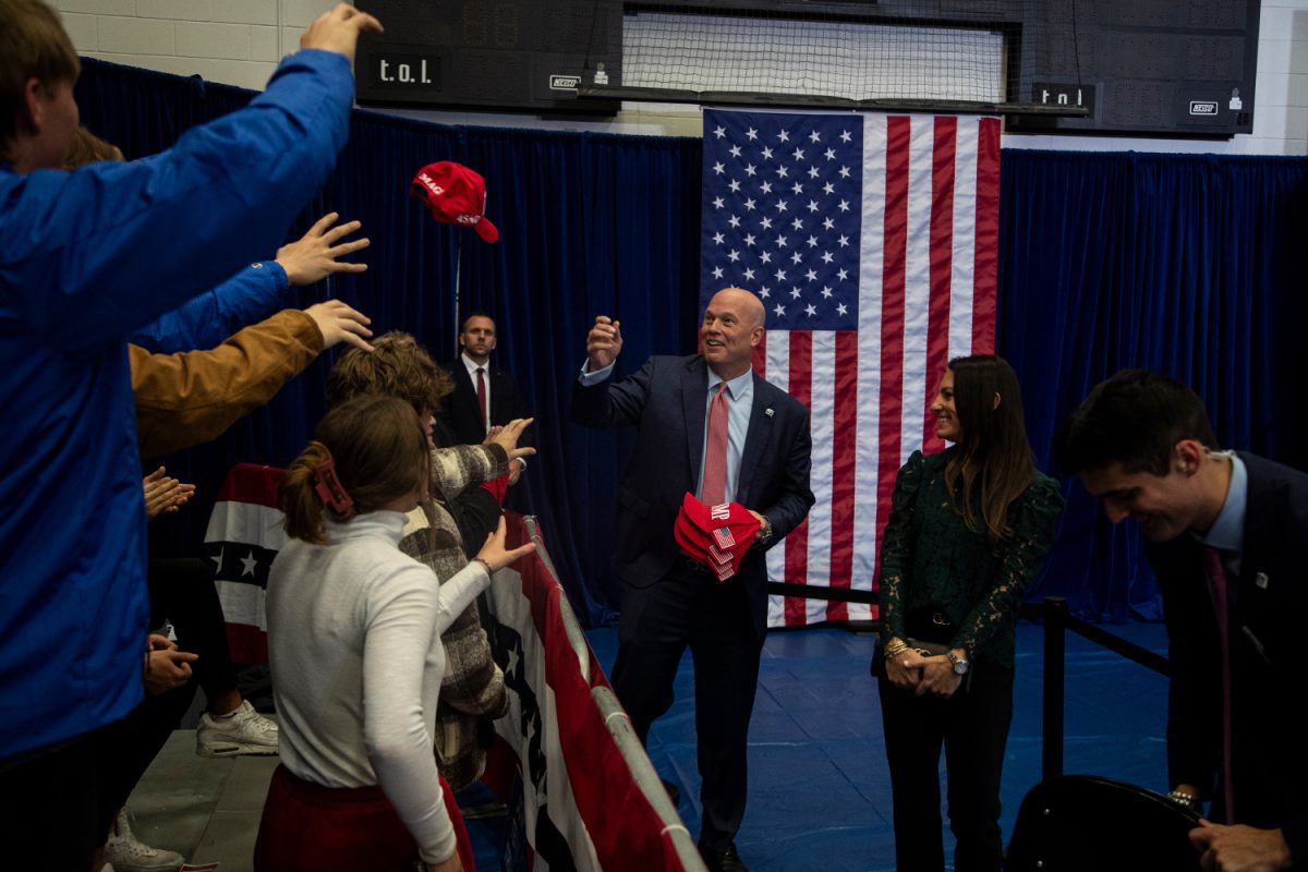 Former United States Attorney General Matt Whitaker throws MAGA hats to attendees during a 2024 presidential campaign rally for former president Donald Trump in Johnson Hall of Kirkwood Community College in Cedar Rapids on Saturday, Dec. 2, 2023. 