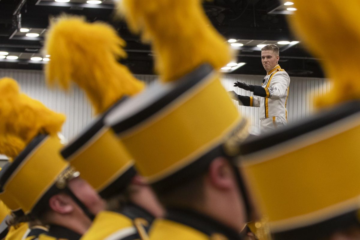Iowa Drum Major Christian Frankl direct the Hawkeye Marching Band durning the Hawkeye Huttle before a football game between No.18 Iowa and No. 2 Michigan at Lucas Oil Stadium in Indianapolis on Saturday, Dec. 2, 2023.