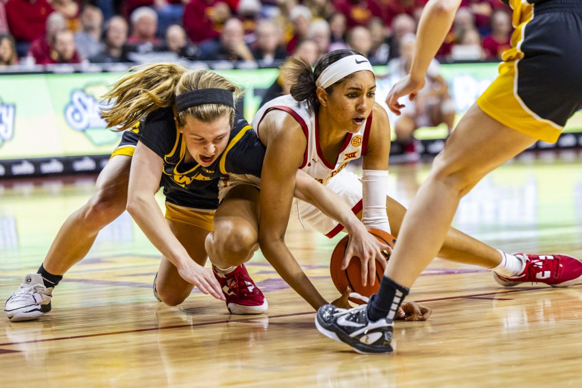 Iowa guard Molly Davis and Iowa State forward Jalynn Bristow fight for the ball during the Iowa Corn Cy-Hawk Series, a basketball game between No. 4 Iowa and Iowa State, at a sold-out Hilton Coliseum in Ames, Iowa, on Wednesday, Dec. 6, 2023. 