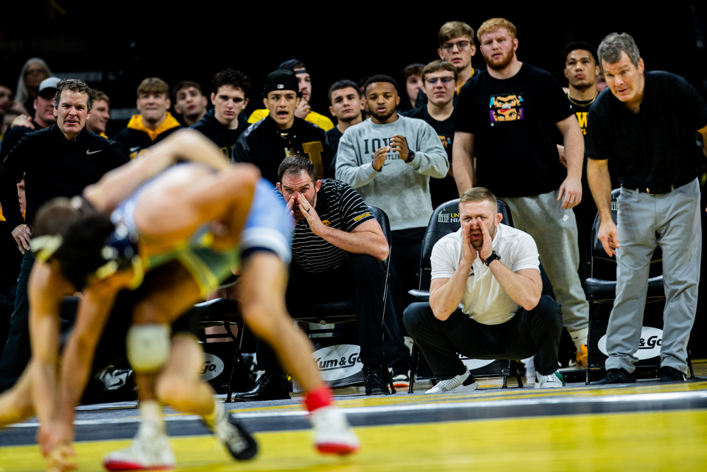 Head Coach Tom Brands and Assistant Coaches Ryan Morningstar and Bobby Telford coach from the sidelines during a dual between Iowa’s 133-pound Cullen Shchriever and Columbia’s 125-pound Nick Babin at Carver-Hawkeye Arena in Iowa City on Friday, Dec. 8, 2023.