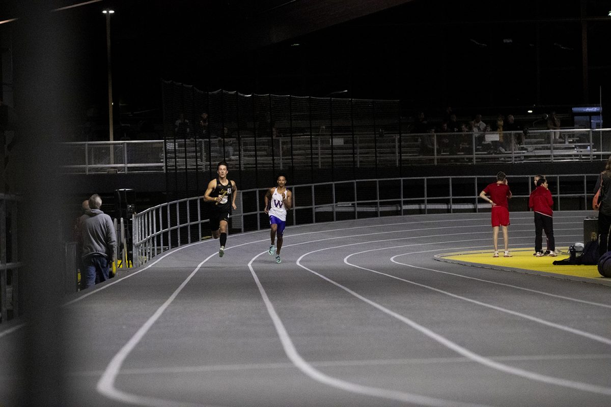 Iowa’s Noah James and Western Illinois’ Malachi Barendilla compete in the 4x400 meter relay during the Jimmy Grant Alumni Invitational at the Hawkeye Indoor Track Facility on Saturday, Dec. 9, 2023. The Hawkeyes hosted Western Illinois and Wisconsin, competing in events including the pentathlon, weight throwing, field events, and various running events at the indoor track.