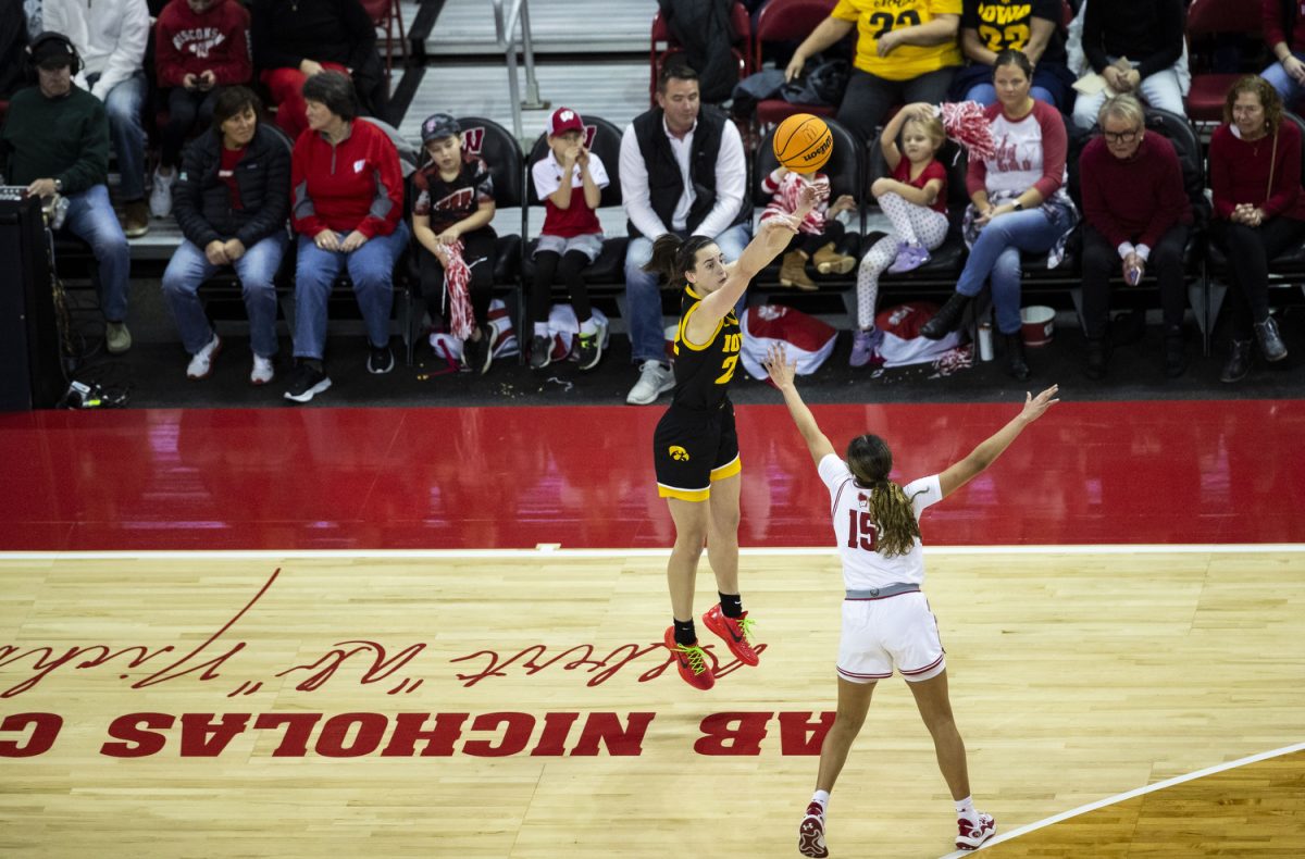 Iowa guard Caitlin Clark shoots a three-pointer during a women’s basketball game between No. 4 Iowa and Wisconsin at a sold-out Kohl Center in Madison, Wisconsin, on Sunday, Dec. 10, 2023. Clark led Iowa in points with 28. The Hawkeyes defeated the Badgers, 87-65.