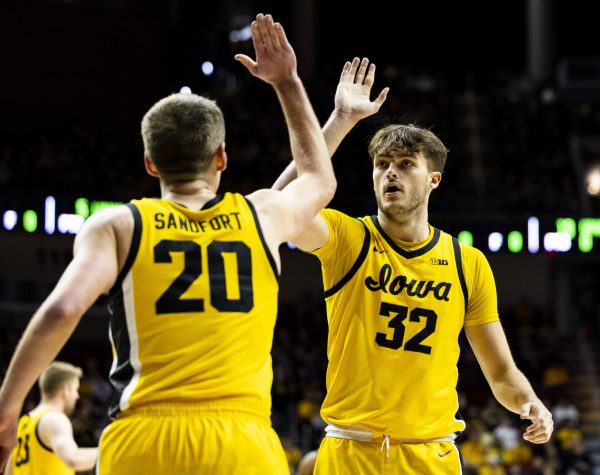 Iowa forward Payton Sandfort and Iowa forward Owen Freeman high five during game one of the Hy-Vee Hawkeye Showcase between Iowa men’s basketball and Florida A&M at Wells Fargo Arena in Des Moines, Iowa, on Saturday, Dec. 16, 2023. The Hawkeyes defeated the Rattlers 88-52.