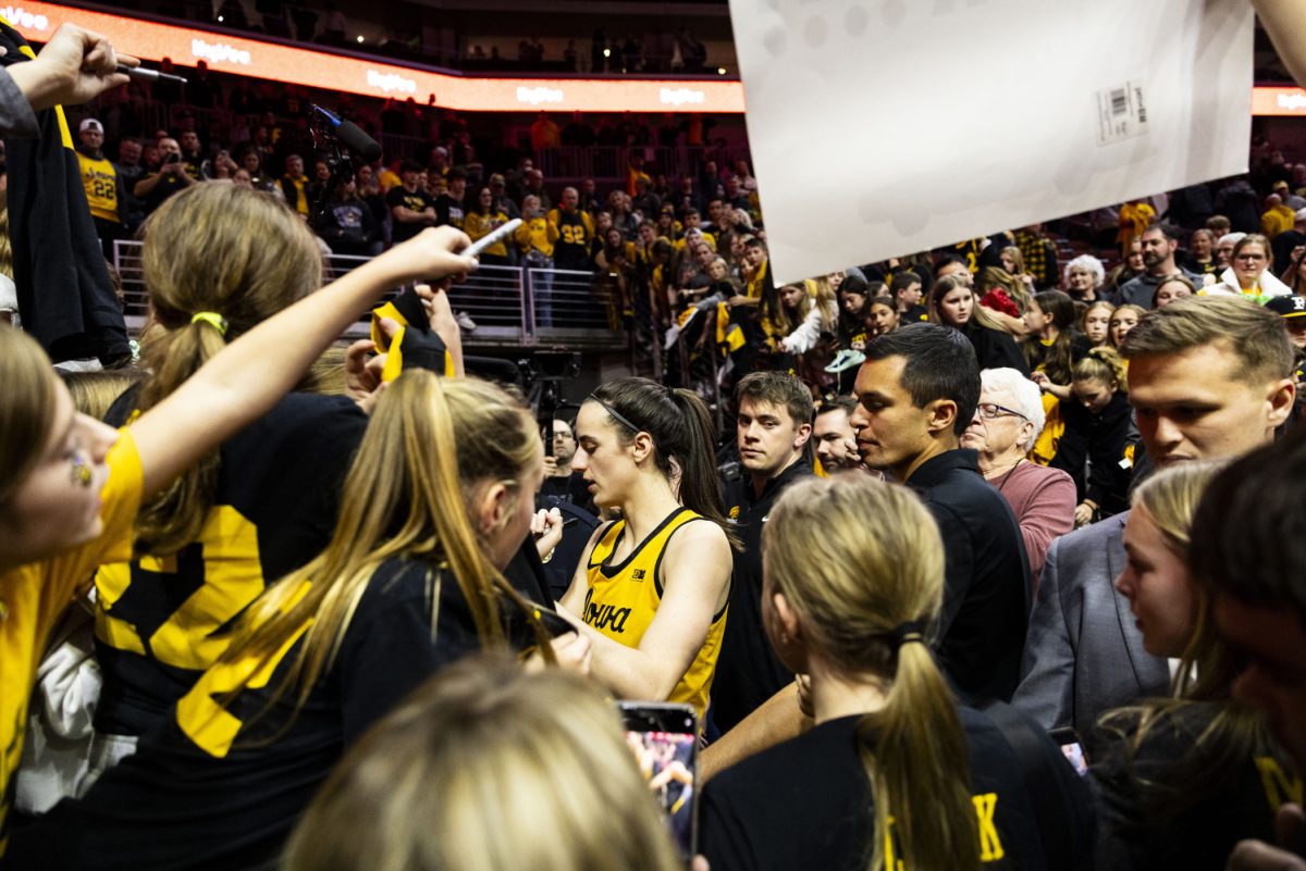 Iowa guard Caitlin Clark signs autographs and greets fans during game two of the Hy-Vee Hawkeye Showcase between No. 4 Iowa women’s basketball and Cleveland State at Wells Fargo Arena in Des Moines, Iowa, on Saturday, Dec. 16, 2023. The Hawkeyes defeated the Vikings, 104-75.