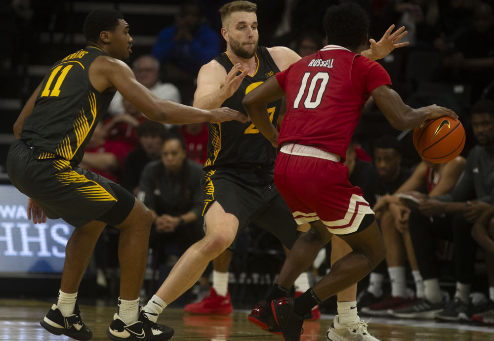 Iowa guard Tony Perkins forward Ben Krikke block Northern Illinois guard Zion Russel during a men’s basketball game between Iowa and Northern Illinois at Carver-Hawkeye Arena on Friday, Dec. 29, 2023. The Hawkeyes defeated the Huskies, 103-74. 