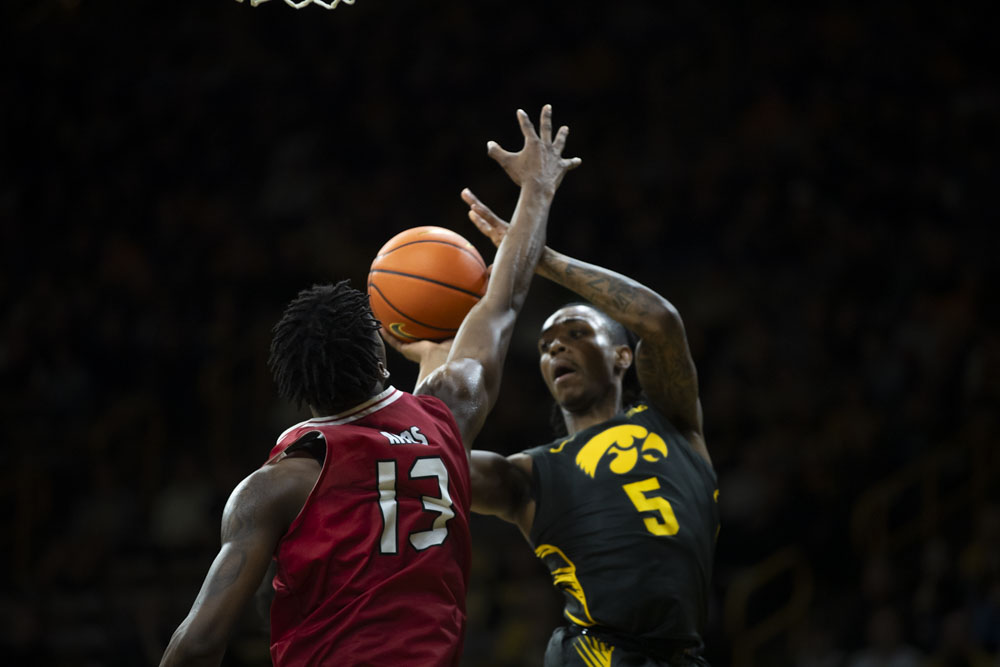 Iowa guard Dasonte Bowen goes for a layup against Northern Illinois forward Xavier Ramos during a men’s basketball game between Iowa and Northern Illinois at Carver-Hawkeye Arena on Friday, Dec. 29, 2023. The Hawkeyes defeated the Huskies, 103-74.