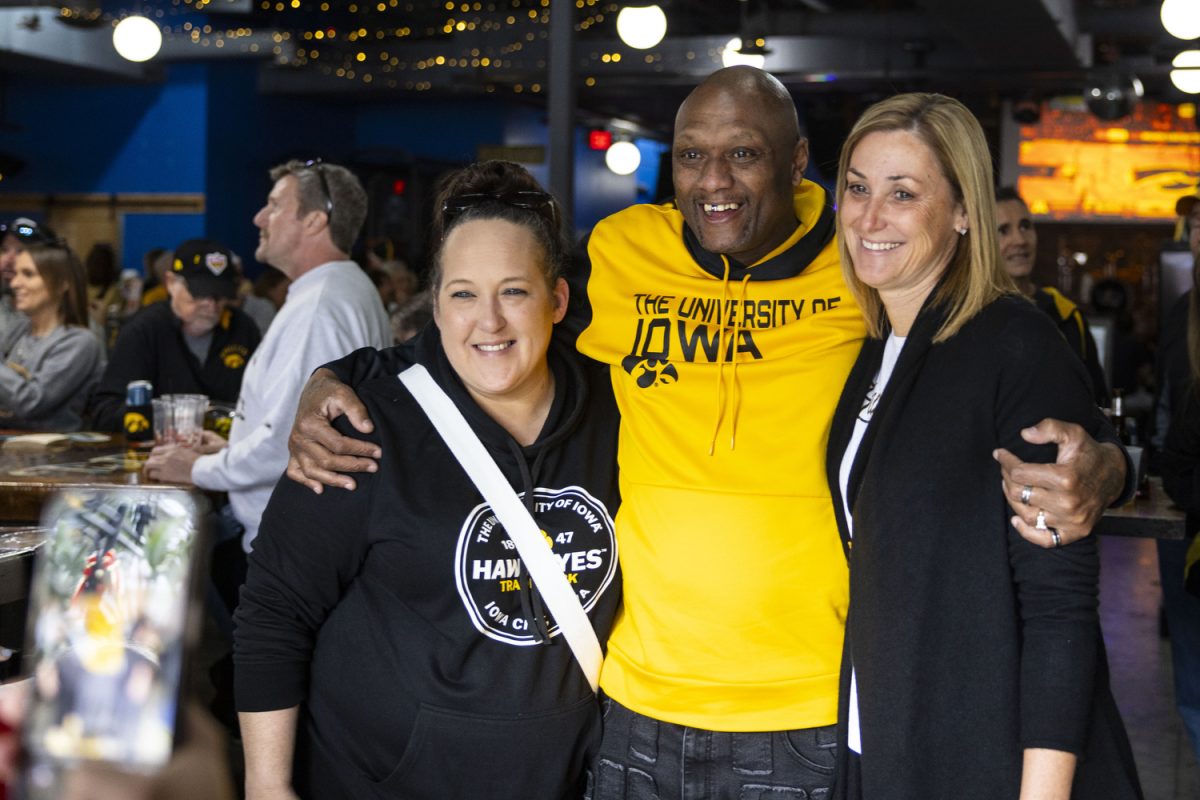 Courtney and Corelly Smith pose for a photo with interim Director of Athletics Beth Goetz during a watch party at Tin Roof in Orlando, Fla., to observe the matchup between No. 4 Iowa women’s basketball and Minnesota that took place in Carver-Hawkeye Arena on Saturday, Dec. 30, 2023. The Hawkeyes defeated the Gophers, 94-71.