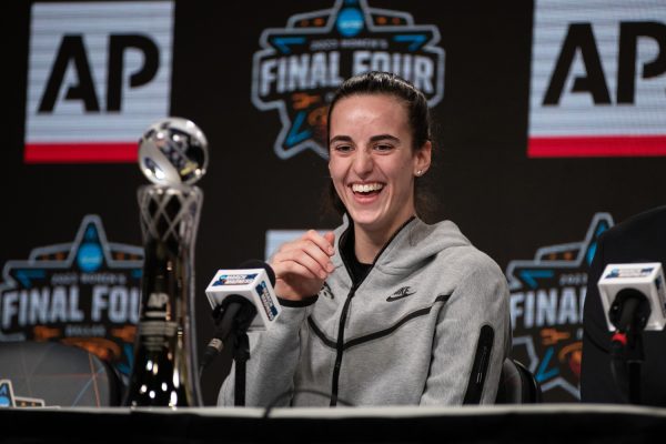 Iowa guard Caitlin Clark laughs while receiving the AP Player of the Year award during a 2023 NCAA Final Four press conferences and open practices at American Airlines Center in Dallas, Texas on Thursday, March 30, 2023.
