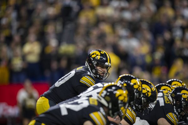 Iowa quarterback Deacon Hill prepares for a play during the Big Ten football championship game between No.18 Iowa and No. 2 Michigan at Lucas Oil Stadium in Indianapolis on Saturday, Dec. 2, 2023. The Wolverines defeated the Hawkeyes 26-0. Hill totaled 120 passing yards and was sacked four times. 