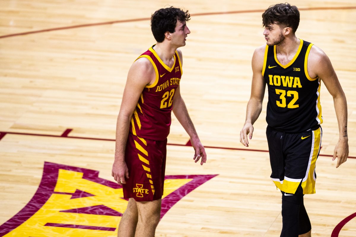 Iowa State forward Milan Momcilovic and Iowa forward Owen Freeman walk past each other during a basketball game between Iowa and Iowa State at Hilton Coliseum in Ames, Iowa on Thursday, Dec. 7, 2023. The Cyclones defeated the Hawkeyes, 90-65.