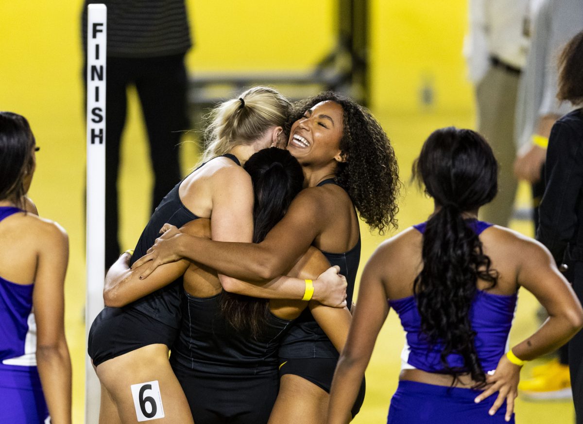 Iowa’s Natalie Harris and Katie Petersen hug Paige Magee after she placed first in the women’s 60-meter hurdles and set a personal and meet record time of 8.07 during the Jimmy Grant Alumni Invitational at the Hawkeye Indoor Track Facility on Saturday, Dec. 9, 2023. The Hawkeyes hosted Western Illinois and Wisconsin, competing in events including the pentathlon, weight throwing, field events, and various running events at the indoor track.