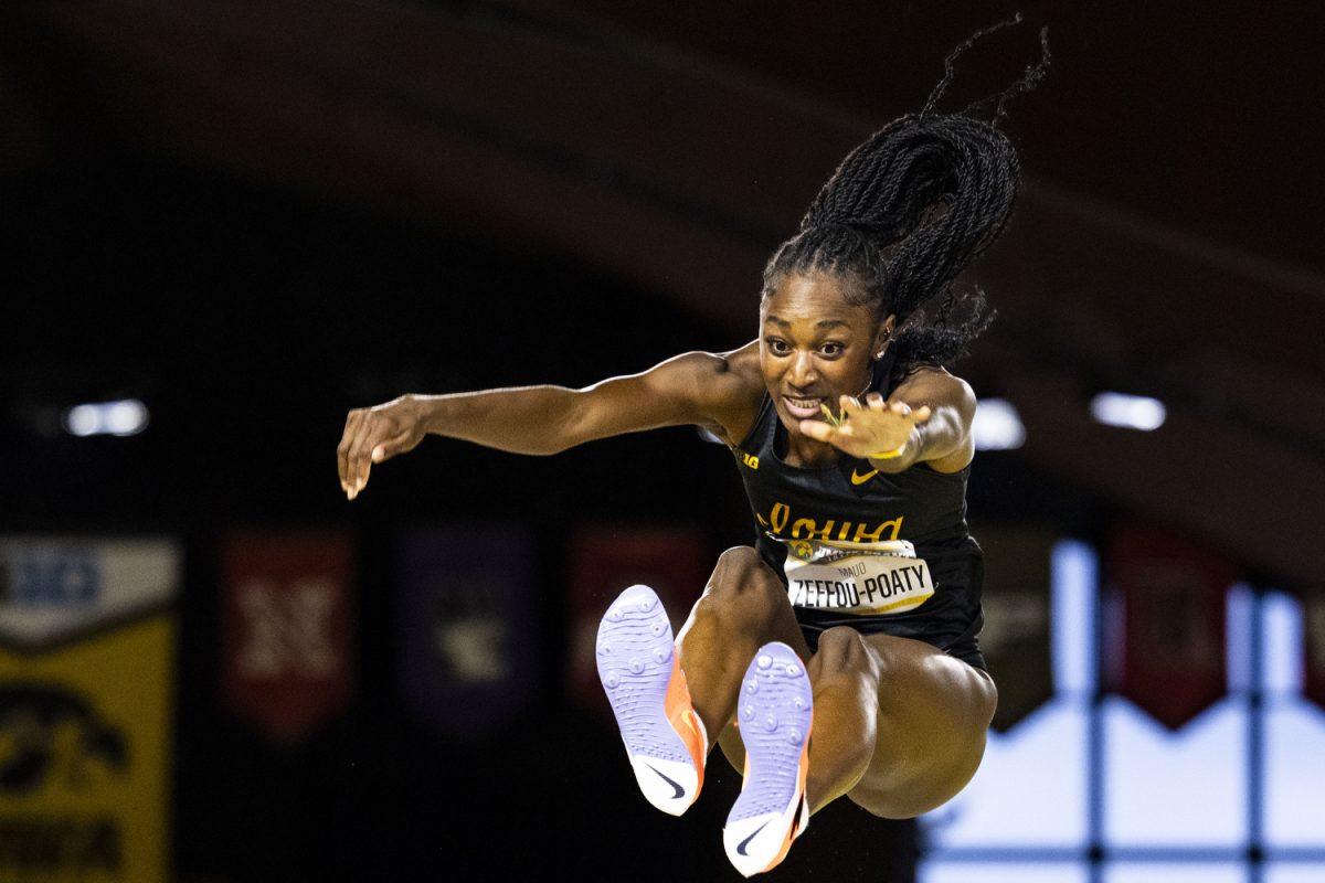 Iowa’s Maud Zeffou-Poaty jumps in the long jump during the Jimmy Grant Alumni Invitational at the Hawkeye Indoor Track Facility on Saturday, Dec. 9, 2023. The Hawkeyes hosted Western Illinois and Wisconsin, competing in events including the pentathlon, weight throwing, field events, and various running events at the indoor track. Zeffou-Poaty placed second with a jump of 5.75 meters.