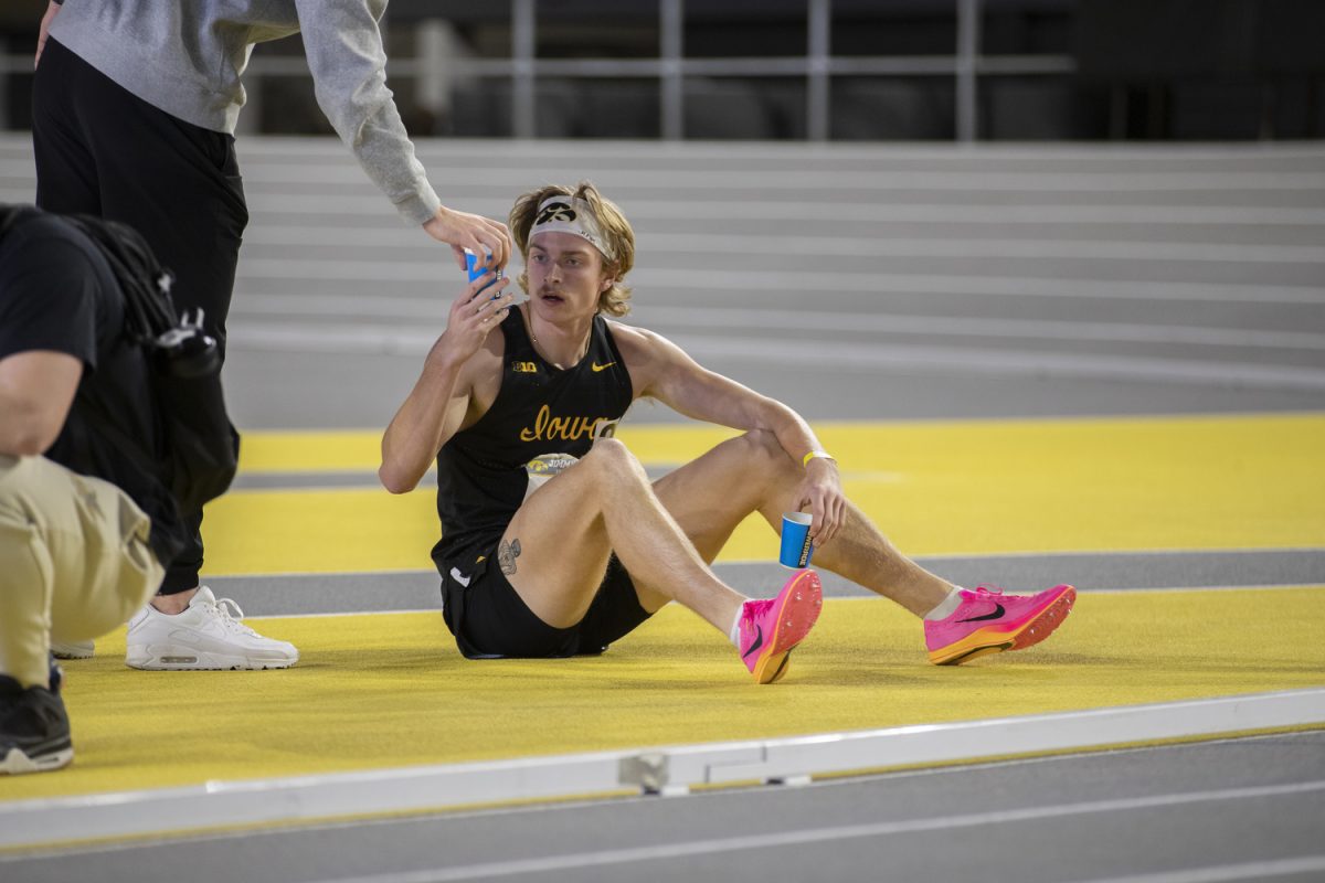 Sal Capaldo gets water after winning the men’s pentathlon 1000-meter race during the Jimmy Grant Alumni Invitational at the Hawkeye Indoor Track Facility on Saturday, Dec. 9, 2023. The Hawkeyes hosted Western Illinois and Wisconsin, competing in events including the pentathlon, weight throwing, field events, and various running events at the indoor track.