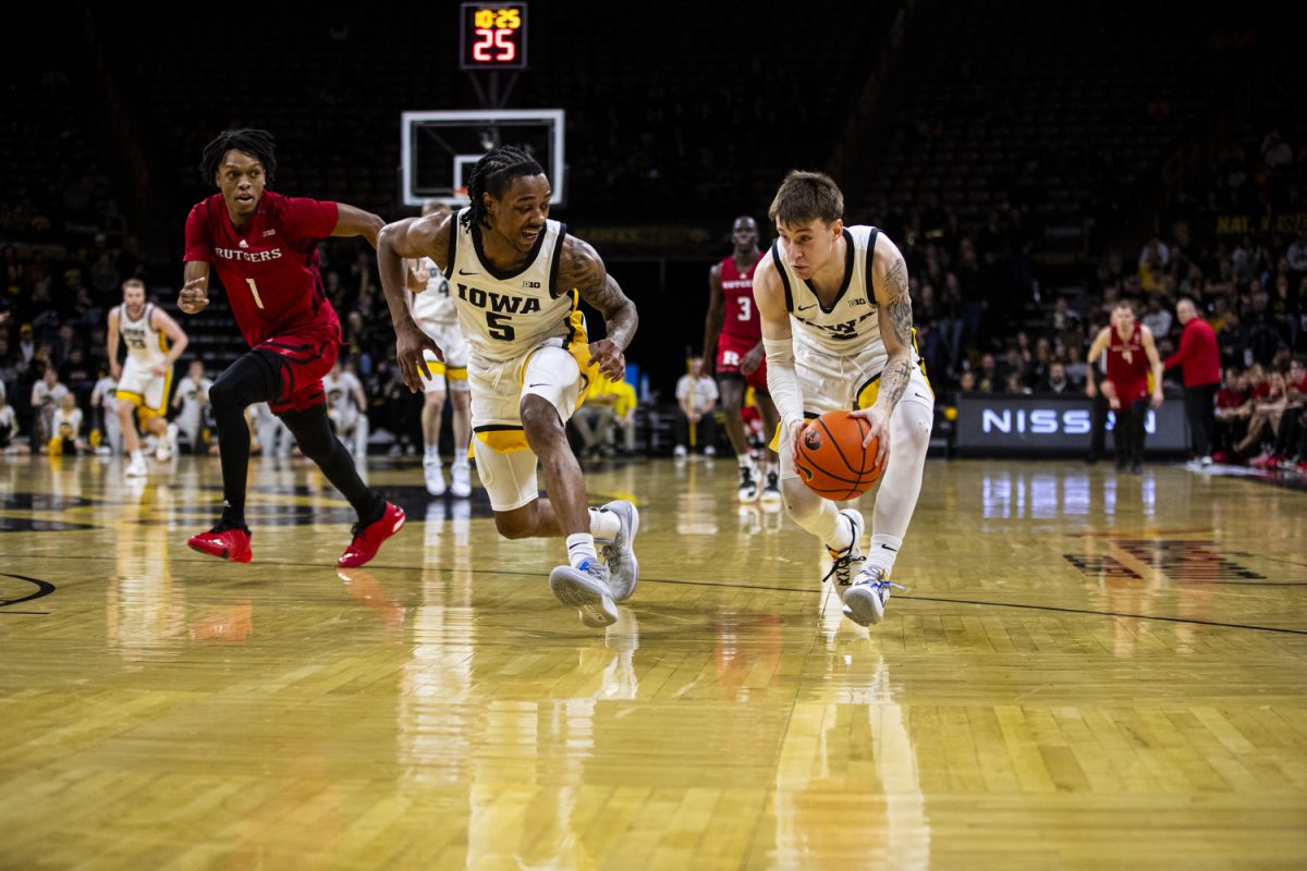 Iowa guards Dasonte Bowen and Brock Harding chase after the ball for a steal during a men’s basketball game between Iowa and Rutgers at Carver-Hawkeye Arena on Friday, Jan. 6. The Hawkeyes defeated the Scarlet Knights, 86-77. The Hawkeyes had 9 steals during the game.