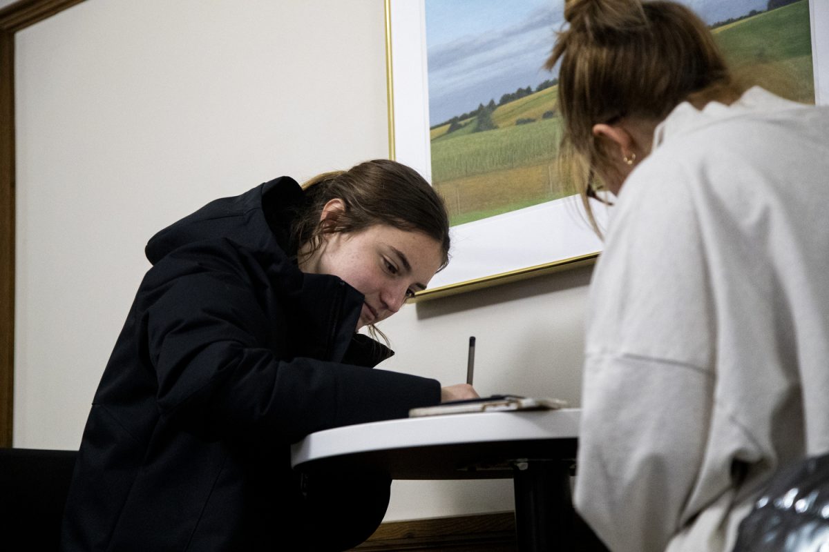 Caucus-goer Laura Swart fills out her voter registration during the Iowa caucuses at the Iowa Memorial Union on Monday, Jan. 15th, 2024. (Carly Schrum/The Daily Iowan)