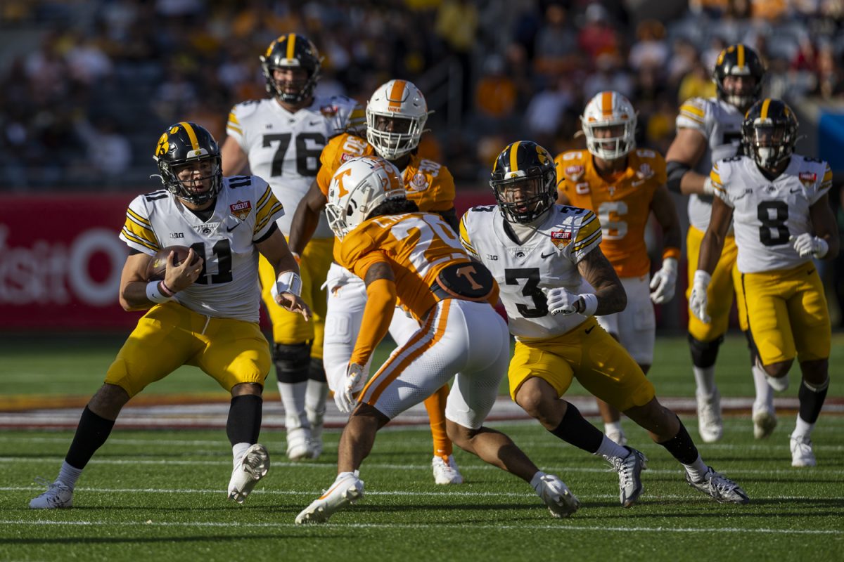 Iowa quarterback Marco Lainez carries the ball during the 2024 Cheez-It Citrus Bowl between No. 17 Iowa and No. 21 Tennessee at Camping World Stadium in Orlando, Fla., on Monday, Jan. 1, 2024. Lainez made his first career start, carrying the ball six times for 51 yards. The Volunteers defeated the Hawkeyes, 35-0. 