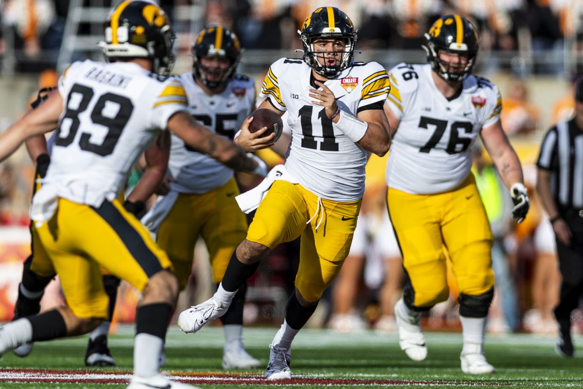 Iowa quarterback Marco Lainez runs with the ball during the 2024 Cheez-It Citrus Bowl between No. 17 Iowa and No. 20 Tennessee at Camping World Stadium in Orlando, Fla., on Monday, Jan. 1, 2024. The Volunteers defeated the Hawkeyes, 35-0.