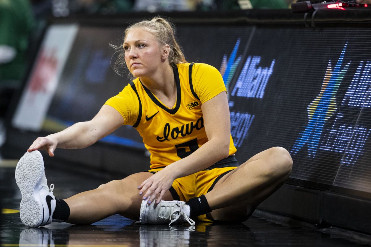 Iowa guard Sydney Affolter stretches on the sideline during a women’s basketball game between No. 4 Iowa and Michigan State in a sold-out Carver-Hawkeye Arena on Tuesday, Jan. 2, 2023.