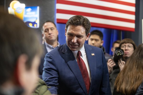 Republican presidential candidate Florida Gov. Ron DeSantis greets attendees during a campaign meet and greet event at McDivots Indoor Sports Pub in Grimes, Iowa on Sunday, Jan. 7, 2024. The Iowa caucuses take place on Jan. 15.
