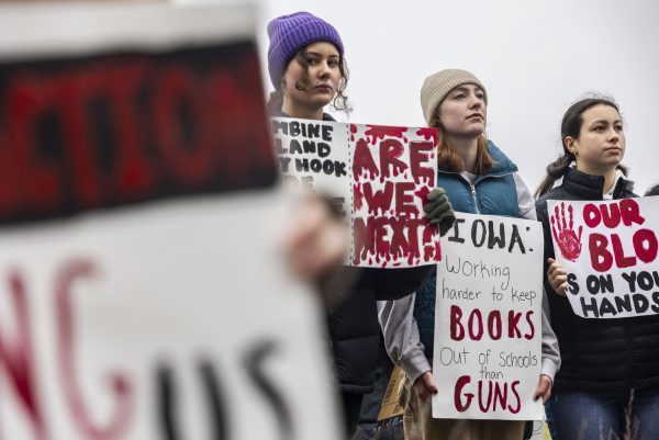 From left; Iowa City High School seniors Vivian Shields, Penelope Wilmoth, and Kalea Seaton listen to a speaker during a walkout for Iowa gun reform in Iowa City on Monday, Jan. 8, 2024. Following the first mass shooting of 2024 at Perry High School on Jan. 4, high school students across Iowa walked out of school in solidarity with the community of Perry. Over a hundred students from various Iowa City schools started outside of Iowa City High School and walked downtown to the Old Capitol on the Pentacrest.