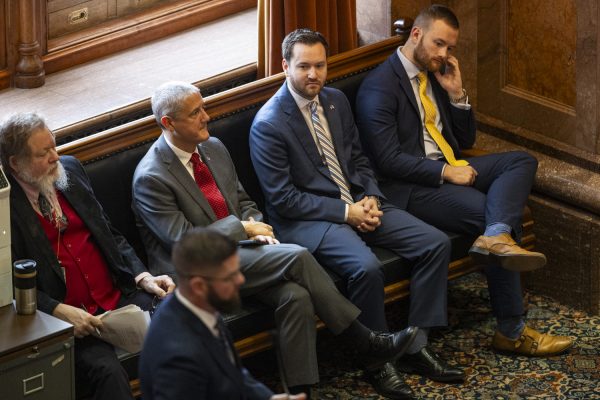 Staffers listen to a representative during the first day of the 2024 Iowa legislative session at the Iowa State Capitol in Des Moines on Monday, Jan. 8, 2024.