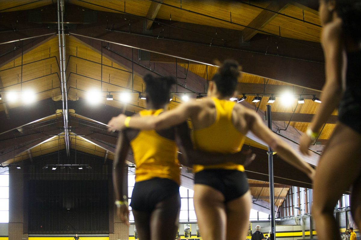 Iowa runners hug after completing the 60m race during the 2024 Hawkeye Invitational at the Hawkeye Indoor Track Facility on Saturday, Jan. 13, 2024. The Hawkeyes hosted ten schools to compete in a variety of field and running events.