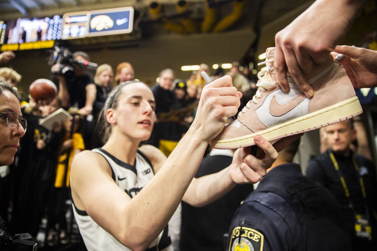 Iowa+guard+Caitlin+Clark+signs+a+young+fans+shoe+after+a+women%E2%80%99s+basketball+game+between+Iowa+and+Indiana+at+Carver-Hawkeye+Arena+on+Saturday%2C+Jan.+13%2C+2024.+The+Hawkeyes+defeated+the+Hoosiers+84-57.