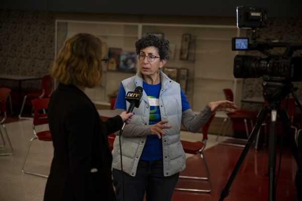 DITV reporter Cara Dulin interviews Iowa State Senator Janice G. Weiner during the Iowa Democratic caucuses at City High School in Iowa City on Monday, Jan. 15, 2024. (Jordan Barry/The Daily Iowan)