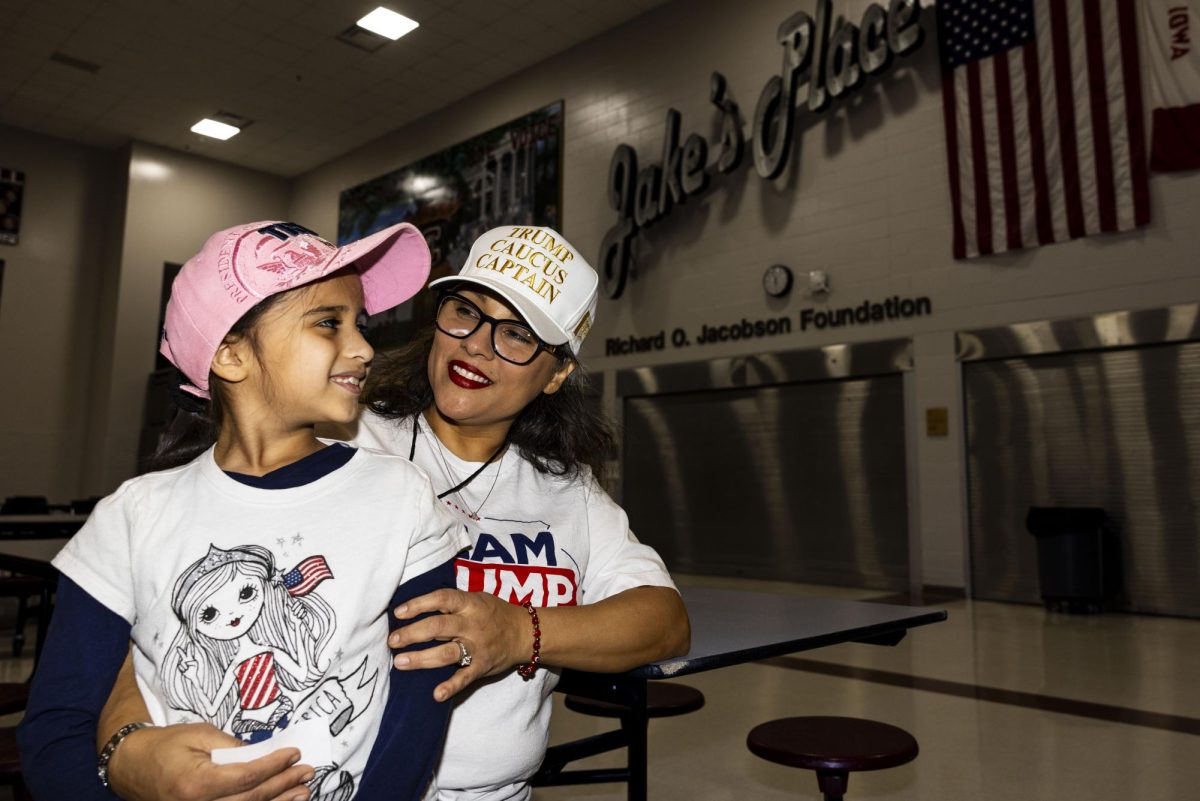 Maggi Sanchez and her daughter Catalina Davila-Sanchez,7, of Des Moines pose for a portrait before the caucus begins at East High School in Des Moines on Monday, Jan. 15, 2024. Precinct Officials and volunteers set up as early caucus-goers entered the cafeteria. (Grace Smith/The Daily Iowan)