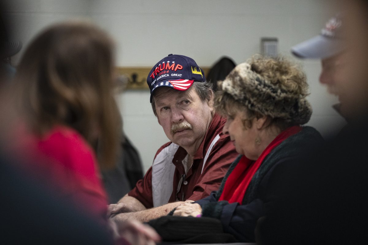 An attendee is seen wearing a Trump hat during the Iowa caucuses at Clear Creek Elementary School in Oxford, Iowa on Monday, Jan. 15, 2024. Trump led the precinct with 32 votes.
