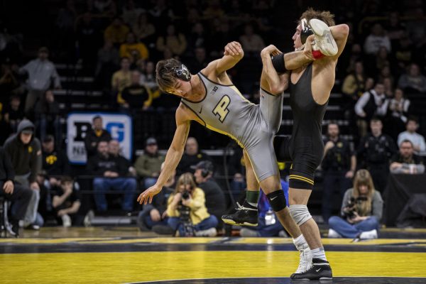 Iowa’s No. 1 125-pound Drake Ayala wrestles Purdue’s No. 2 Matt Ramos during a wrestling dual between No. 3 Iowa and Purdue at Carver-Hawkeye Area on Friday, Jan. 19, 2024. The Hawkeyes defeated the Boilermakers, 34-6. Ramos defeated Ayala by decision, 4-1.