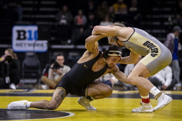 Iowa’s No. 1 141-pound Real Woods wrestles Purdue’s No. 32 Greyson Clark during a wrestling dual between No. 3 Iowa and Purdue at Carver-Hawkeye Area on Friday, Jan. 19, 2024. The Hawkeyes defeated the Boilermakers, 34-6. Woods defeated Clark by major decision, 8-0.