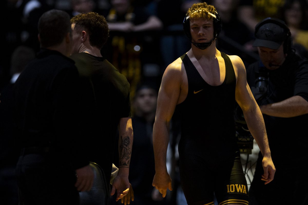 Iowa’s 184-pound Aiden Riggins walks towards the mat during a wrestling dual between No. 3 Iowa and Purdue at Carver-Hawkeye Arena on Friday, Jan. 19, 2024. The Hawkeyes defeated the Boilermakers, 34-6. Purdue’s James Rowley defeated Riggins by decision, 5-1.