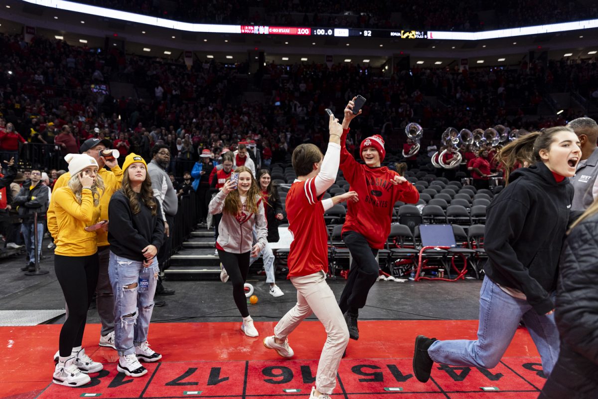 Ohio State fans storm the court after a basketball game between No. 2 Iowa and No. 18 Ohio State at Value City Arena in Columbus, Ohio, on Sunday, Jan. 21, 2024. The Buckeyes defeated the Hawkeyes, 100-92. While fans ran onto the court, one of them knocked down Iowa guard Caitlin Clark.