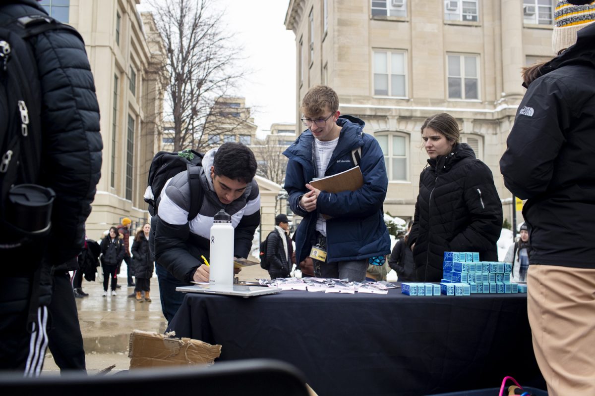 Members of Undergraduate Student Government hand out nightcaps and birdies at Kautz Plaza in Iowa City on Monday, Jan. 22, 2024. The distribution was part of a larger collaboration with Campus Safety to encourage personal safety and awareness efforts within students.