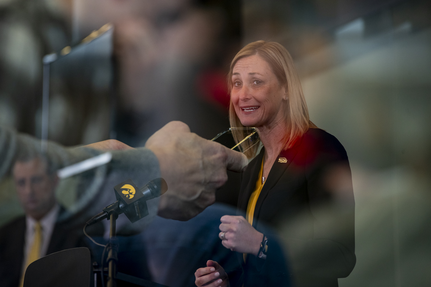 A double exposure image of a reporter live tweeting a quote from Athletic Director Beth Goetz during an introductory press conference at Carver-Hawkeye Arena on Tuesday, Jan. 23, 2024. Goetz is the first woman in the Big Ten conference to be hired into the roll of athletic director.