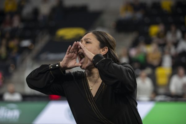 Iowa head coach Larissa Libby yells “Go Hawks” as the crowd wishes her a happy birthday during a gymnastics meet between No. 20 Iowa and No. 41 Southern Utah at Xtream Arena in Coralville on Friday, Jan. 26, 2024. The Hawkeyes defeated the Thunderbirds 195.800 to 195.425. (Isabella Tisdale/The Daily Iowan)