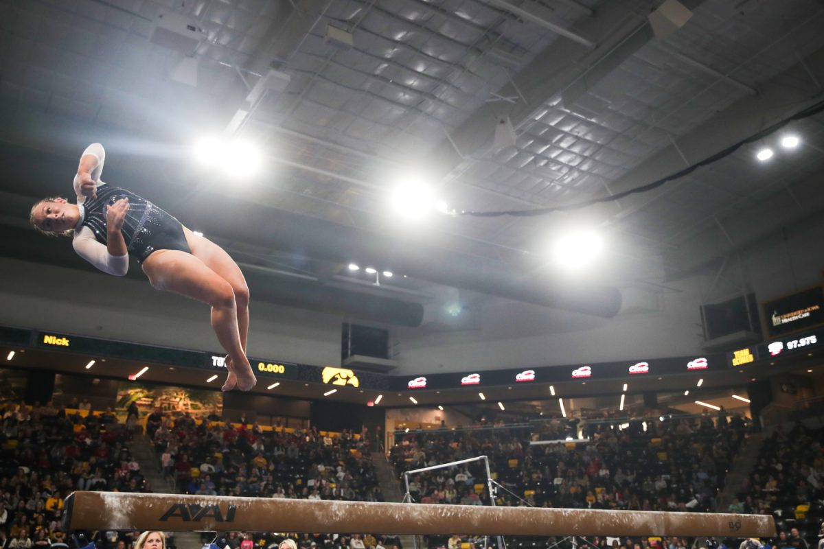 Iowa gymnast Eva Volpe performs on the beam during a gymnastics meet between No. 20 Iowa and No. 41 Southern Utah at Xtream Arena in Coralville on Friday, Jan. 26, 2024. The Hawkeyes defeated the Thunderbirds, 195.800 to 195.425. Many fans dressed up for Taylor Swift Day at the meet.