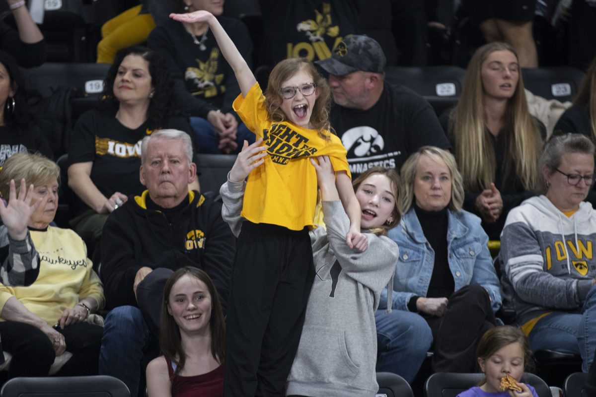 Iowa fans cheer for a t-shirt during a gymnastics meet between No. 20 Iowa and No. 41 Southern Utah at Xtream Arena in Coralville on Friday, Jan. 26, 2024. The Hawkeyes defeated the Thunderbirds 195.800 to 195.425. 3,105 attendees came to watch the matchup. (Isabella Tisdale/The Daily Iowan)
