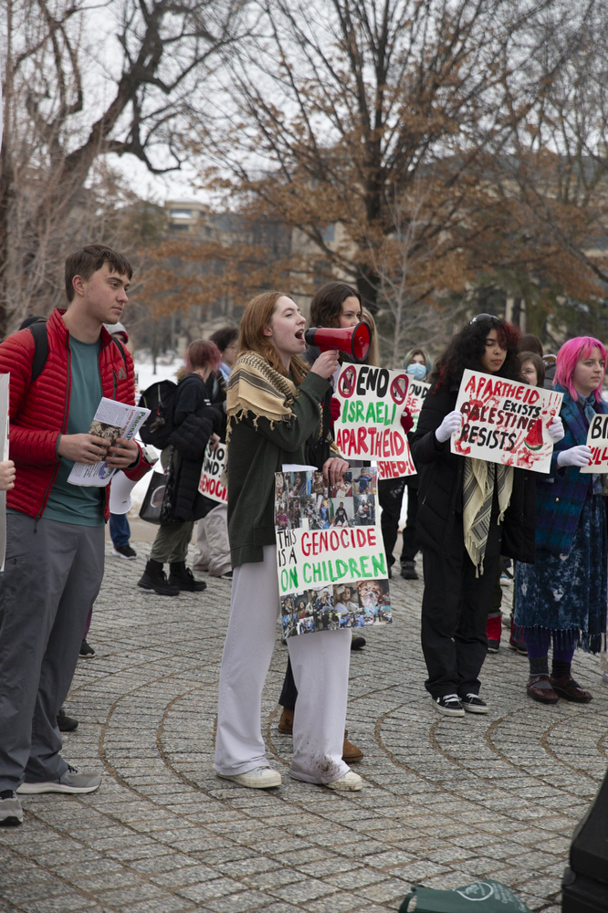 Protesters chant during a protest in support of Palestinian people, held by Iowans For Palestine, at the University of Iowa Pentacrest in Iowa City on Friday, Jan. 26, 2024. Iowans for Palestine were joined by community members and a City High School walkout, who voiced frustration and anger over the Jan. 18 Iowa House of Representatives resolution that supports Israel and condemns Hamas’ Oct. 7 attack. About 50 protesters yelled chants and marched around downtown after the chants.