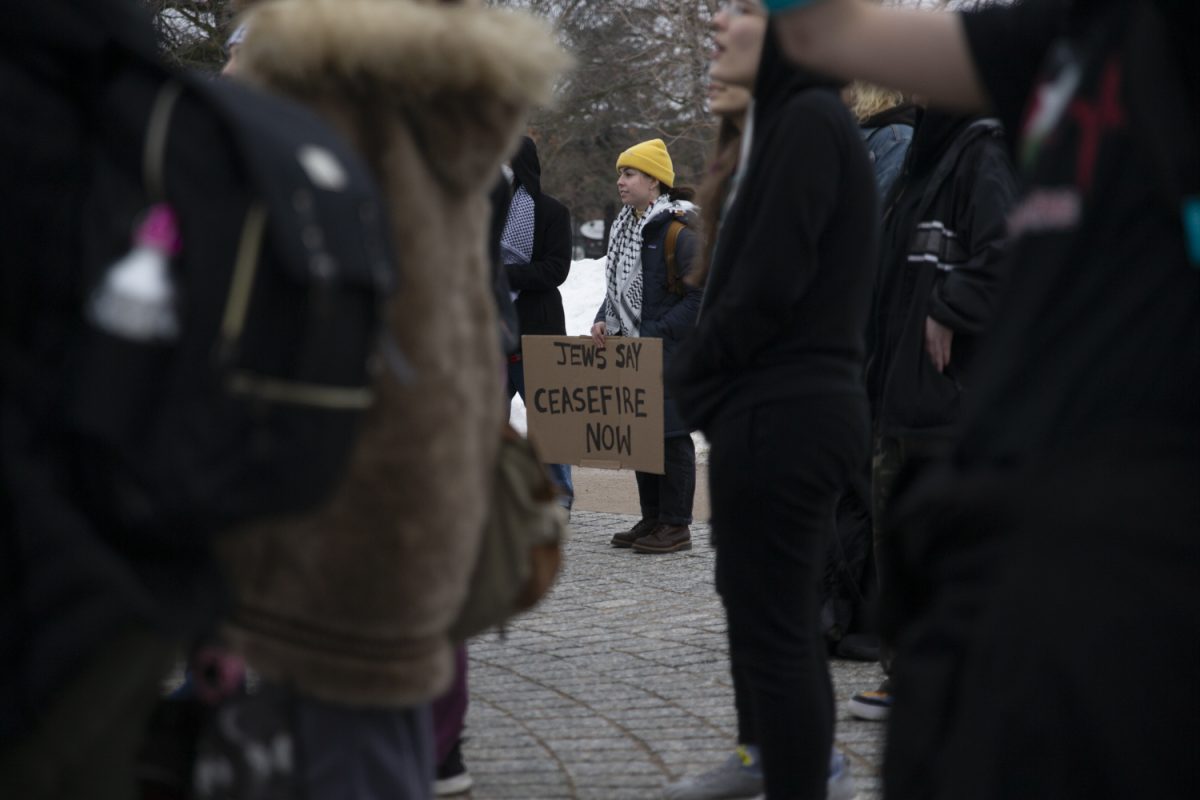 A protester holds a sign during a protest in support of Palestinian people, held by Iowans For Palestine, at the University of Iowa Pentacrest in Iowa City on Friday, Jan. 26, 2024. Iowans for Palestine were joined by community members and a City High School walkout, who voiced frustration and anger over the Jan. 18 Iowa House of Representatives resolution that supports Israel and condemns Hamas’ Oct. 7 attack. About 50 protesters yelled chants and marched around downtown after the chants.