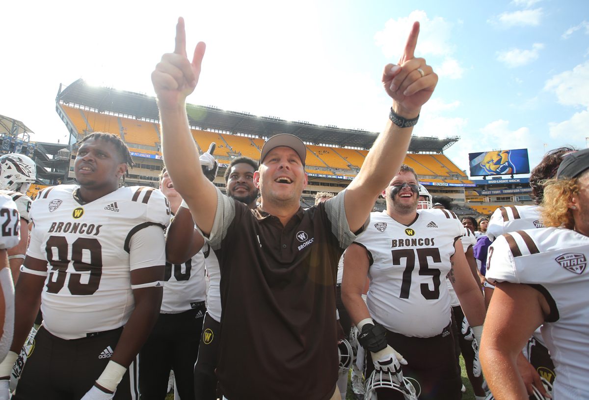 Sep 18, 2021; Pittsburgh, Pennsylvania, USA; Western Michigan Broncos head coach Tim Lester (middle) and players react to their fans after defeating the Pittsburgh Panthers at Heinz Field. The Broncos won 44-41. Mandatory Credit: Charles LeClaire-USA TODAY Sports